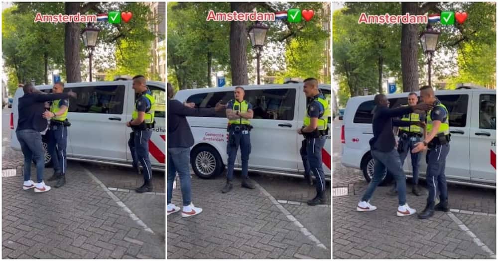 Amsterdam, Netherlands, black man, white policemen, hugs them, walks away