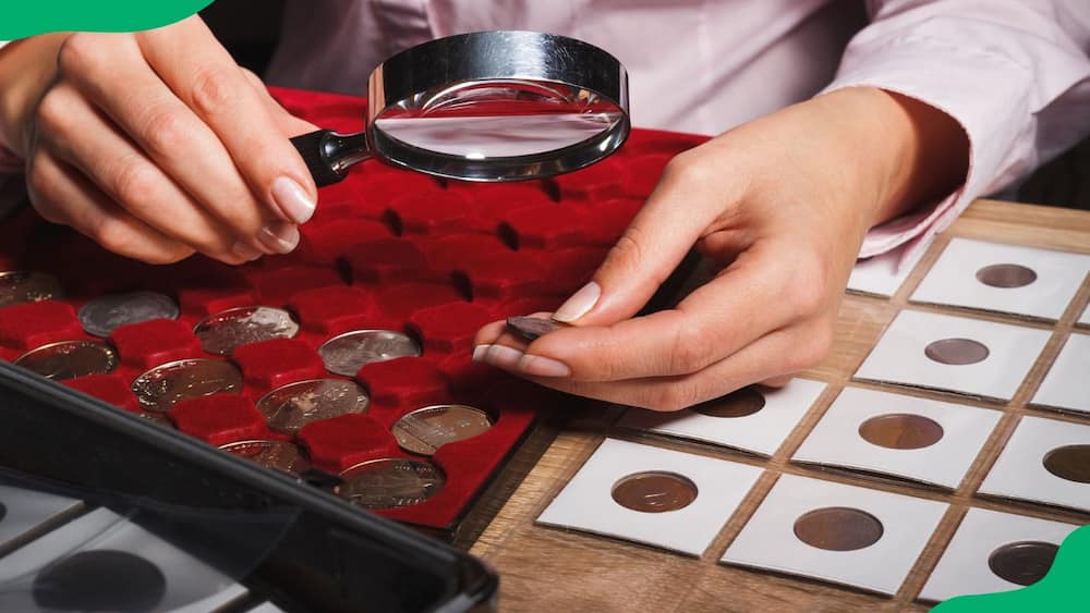 A woman inspecting old coins