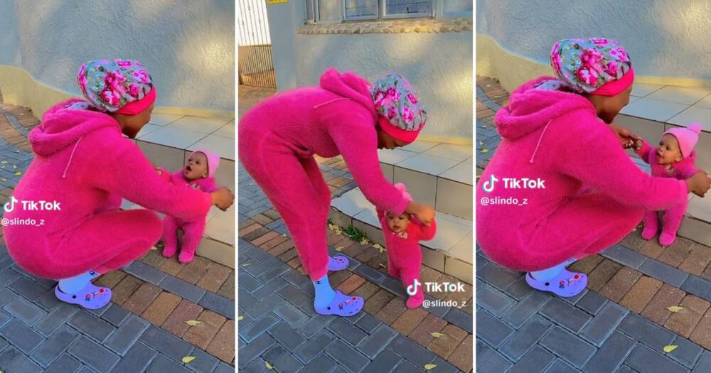 A video of a 25-year-old woman wearing matching pink onesies with her baby sister