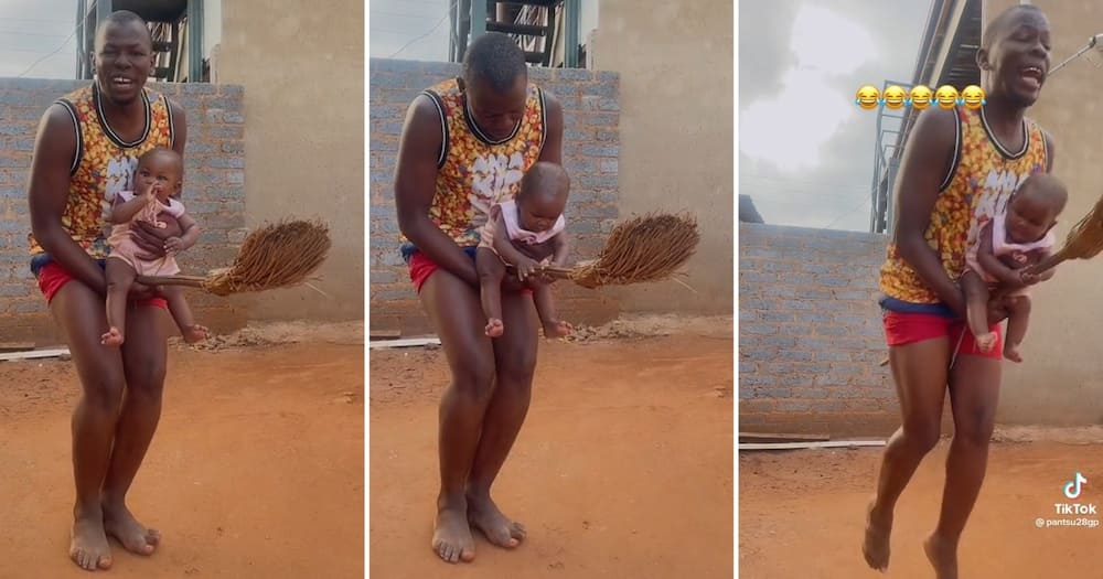 Limpopo man holding his daughter and a broom