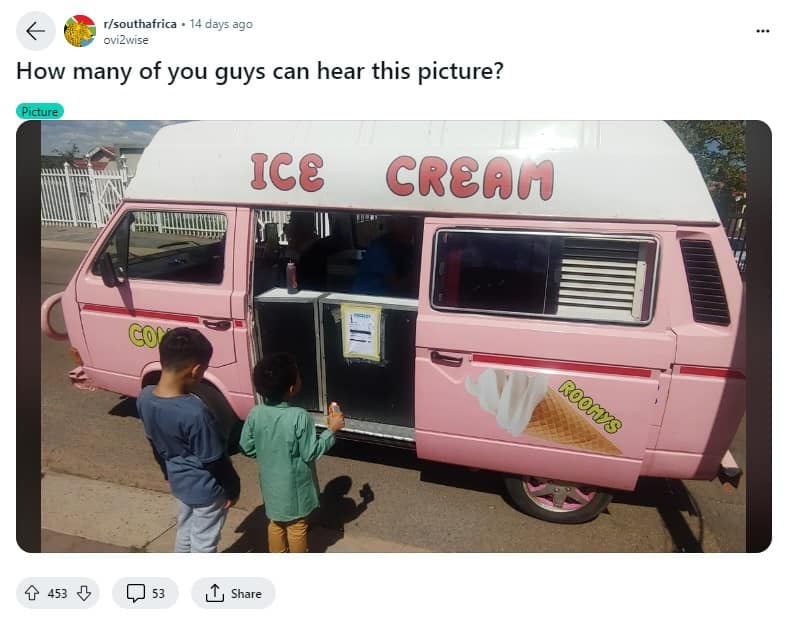 Pink ice cream van parked in the road