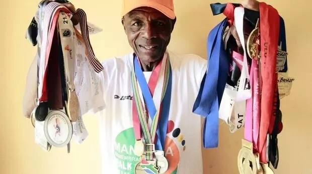Raphulu shows off his medals. Photo: ANA