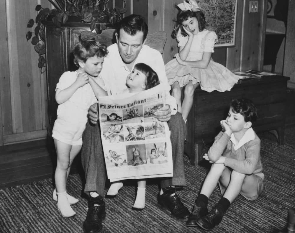 John Wayne (1907-1979) with his four children Patrick, Melinda, Toni, and Michael at the family home in Encino, California, circa 1943.