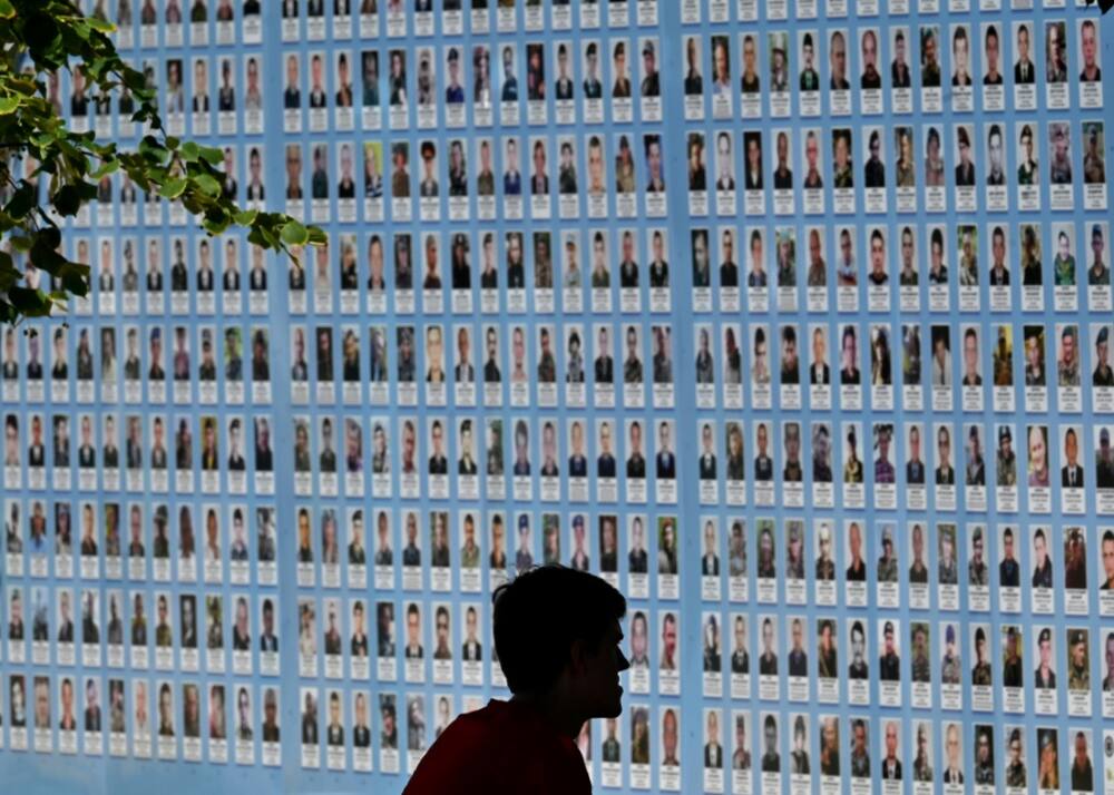 A memorial wall in Kyiv displays images of Ukrainian troops killed since Russia's invasion