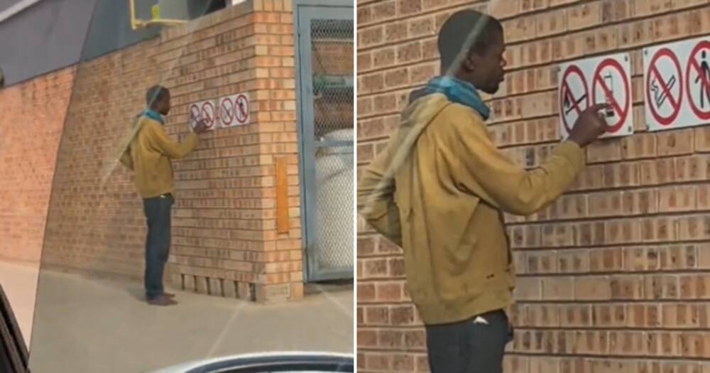 A homeless man dialling the numbers on the picture of a cellphone.