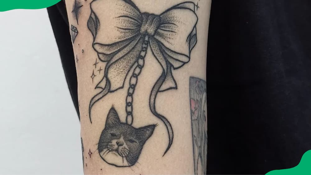 Tied up cat tattoo