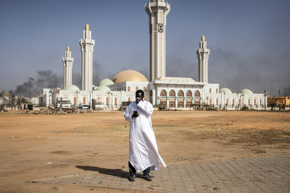 A man covers his face to protect from tear gas as protesters clashed with police in Dakar last week