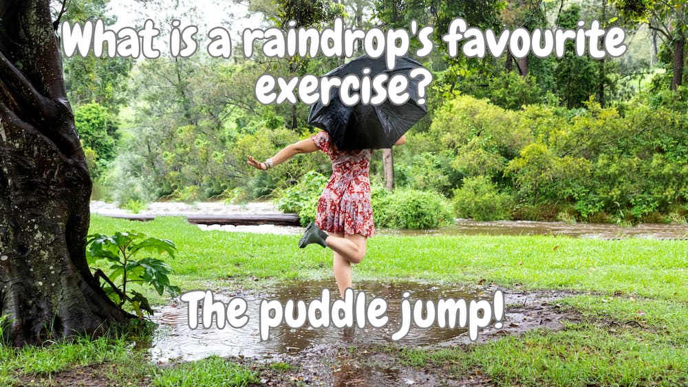 Lady jumping in a puddle