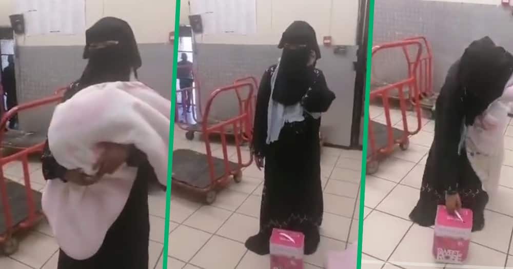 Woman dressed in hijab stealing wine in a shop
