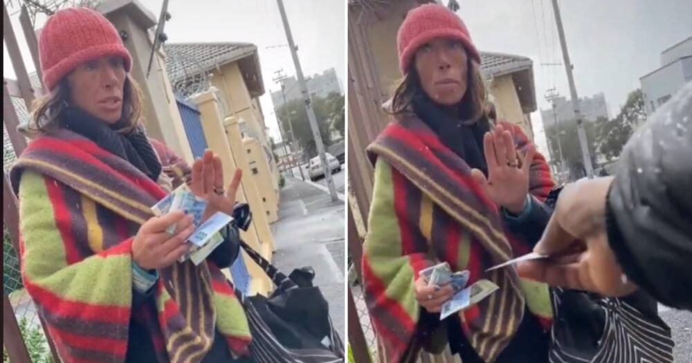 Bi Phakathi hands out money to a homeless woman