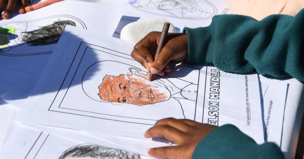 Child colouring in picture of Nelson Mandela