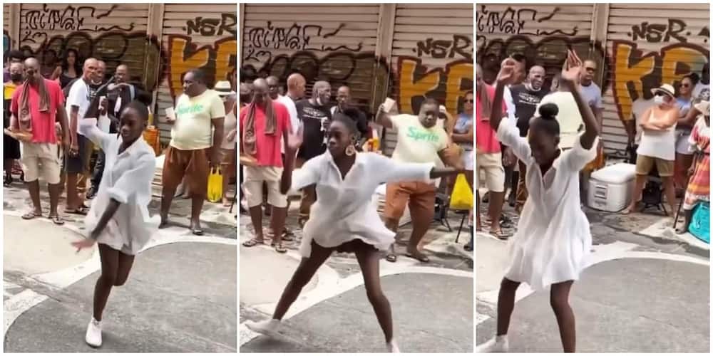 Lady in dress serves sterling dance moves with her legs apart, causes people to fight over her in cute video
