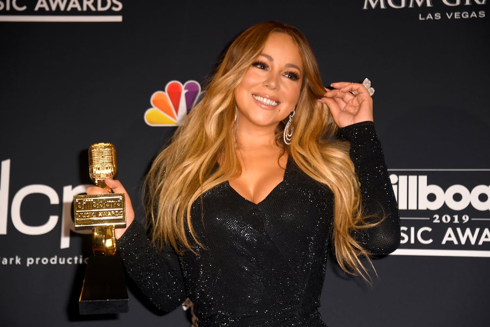 Mariah Carey poses with the Icon Award in the press room