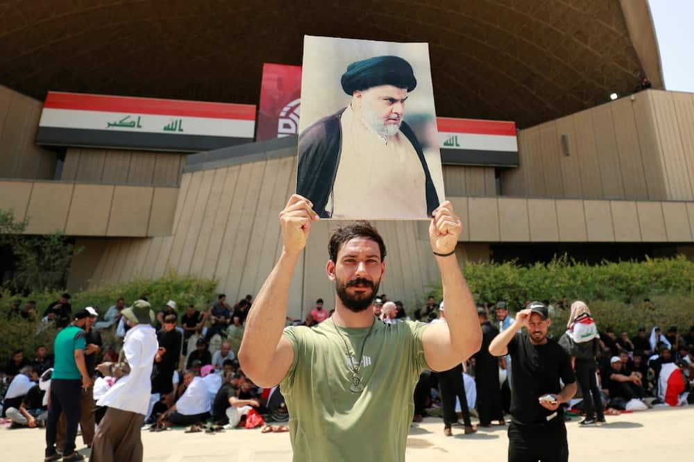 A Sadr supporter displays his portrait near the occupied parliament