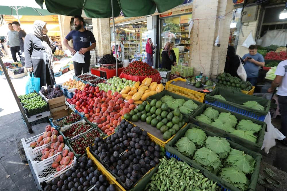 Iranians buy fresh produce at the Tajrish Bazaar market in Tehran. Inflation is making an unwelcome comeback globally -- stoked by high energy and food prices, driven largely by Russia's invasion of Ukraine, and by related sanctions on Moscow