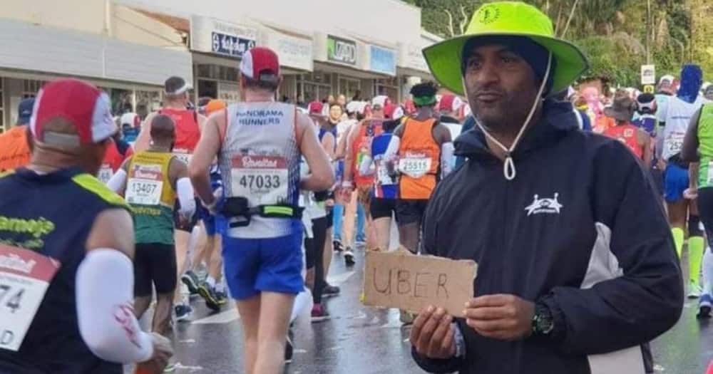 Man holding Uber sign at The Comrades Marathon