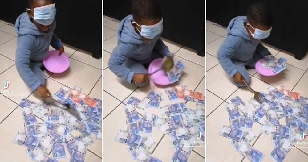 Child scooping money onto a plate while blindfolded
