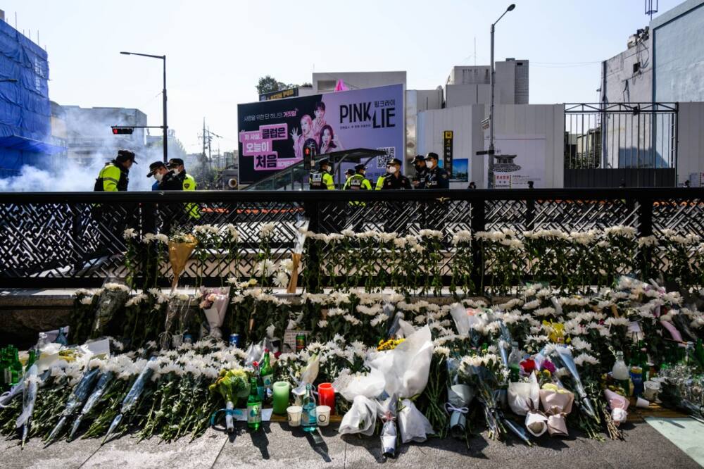 Flowers tributes are seen at a makeshift memorial outside a subway station in Seoul's Itaewon district, two days after a deadly Halloween surge in the area