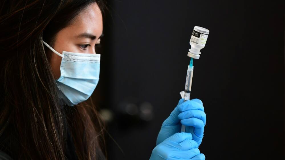 A health worker prepares to administer a vaccine in Los Angeles, California in January 2022