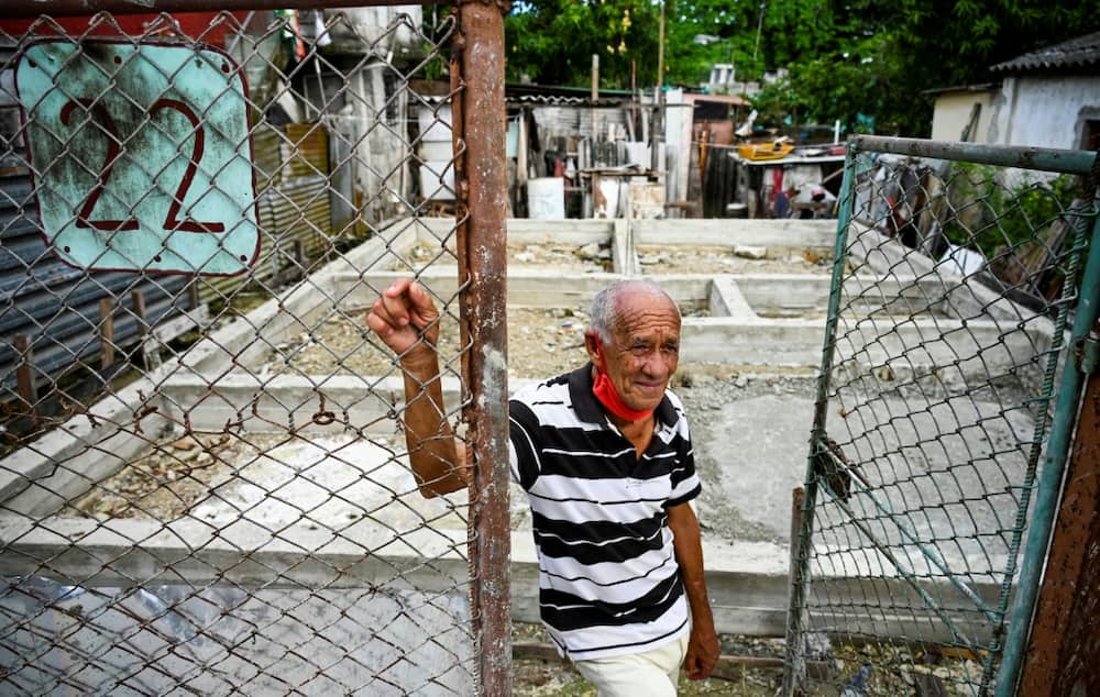 Jorge Gil, a representative of the Communist Party of Cuba, stands in front of the foundation of his house which was demolished as part of a neighborhood improvement program but never rebuilt