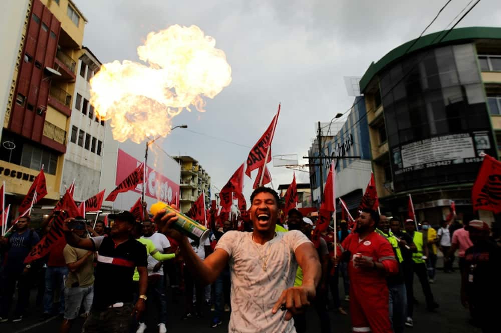 A protester sprays fire during a march against the high cost of food and fuel in Panama City