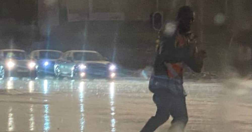 South Africans, Inspired, by Car Guard, Directing Traffic, in Heavy Rain, Johannesburg