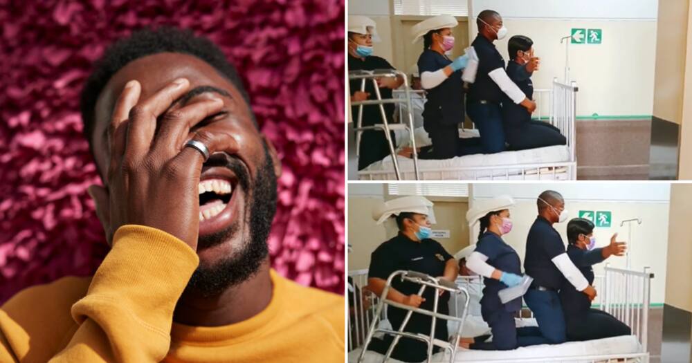 Man laughing ta hospital staff acting out Titanic