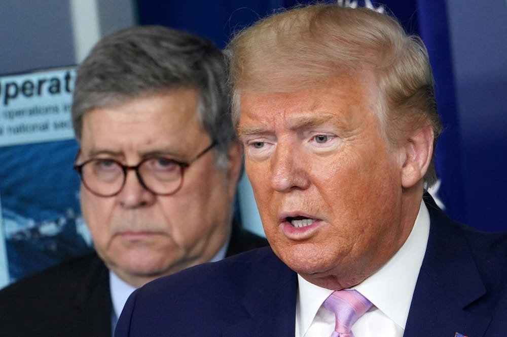 US President Donald Trump considered installing a loyalist at the top of the Justice Department after the resignation of his attorney general Bill Barr (left)