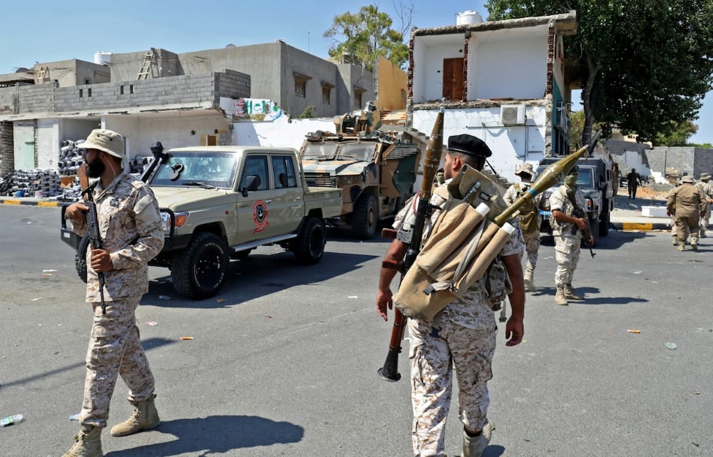 Members of the 444 Brigade affiliated with Libya's defence ministry man positions in the area of an overnight gunbattle in Tripoli's suburb of Ain Zara