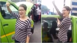 Reactions as video of white lady serving as taxi assistant surfaces