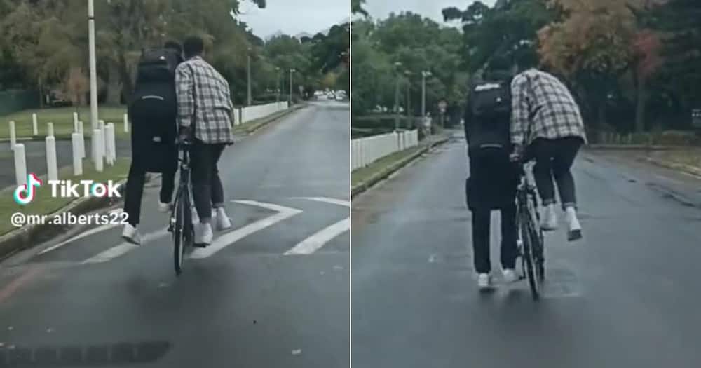 Men in Stellenbosch ride bike as one person