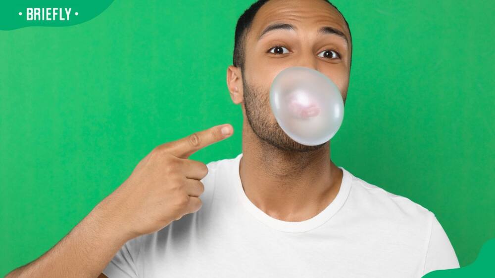 A man pointing to his bubble gum