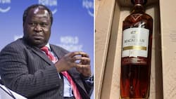 Tito Mboweni shows off the only birthday gift he received, a bottle of scotch whiskey worth R3 500