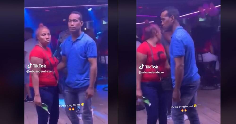 Woman holds broken botle while dancing with man