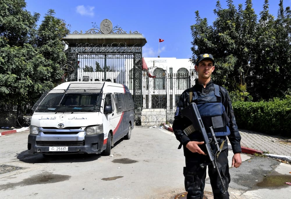 A Tunisian security guard stands guard outside parliament in Tunis on March 31, 2022