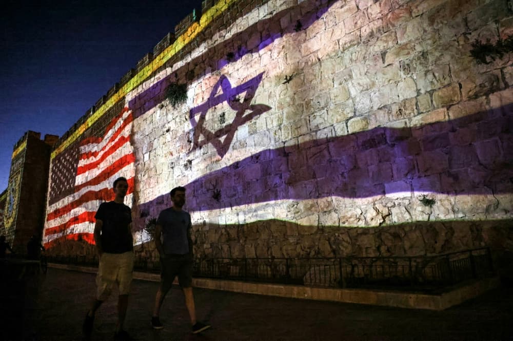The Israeli and US flags are projected against the wall of Jerusalem's Old City during the visit by US President Joe Biden, who will meet with Israeli and Palestinian leaders before flying onwards to Saudi Arabia