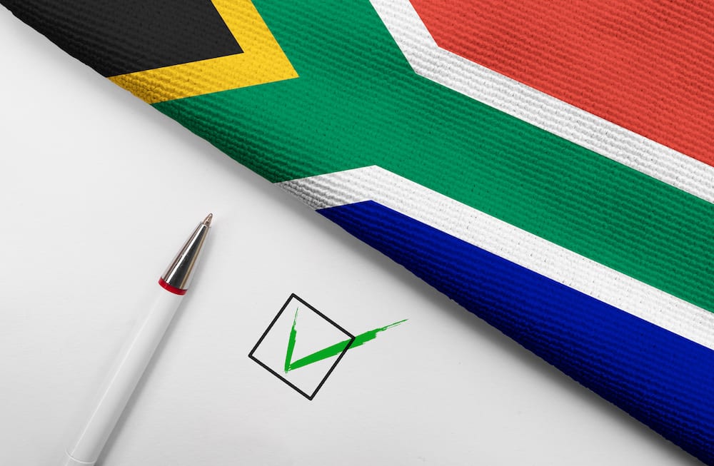 South African flag on white background with check box and pen
