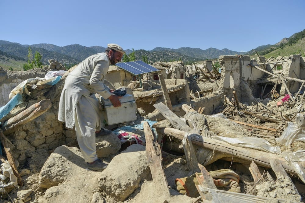 A villager searches for valuables in the ruins of his home at Wuchkai, just 10 kilometres (6 miles) from the epicentre of the deadly Afghan quake