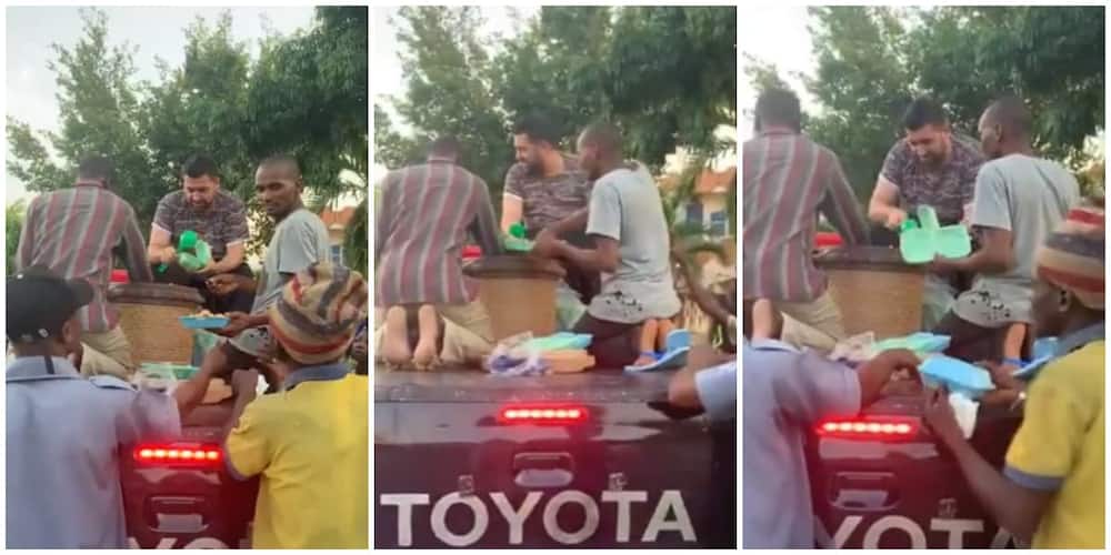 Nigerian White Man Feeds 150 People From the Top of a Car, Video Goes Viral, Sparks Huge Reactions