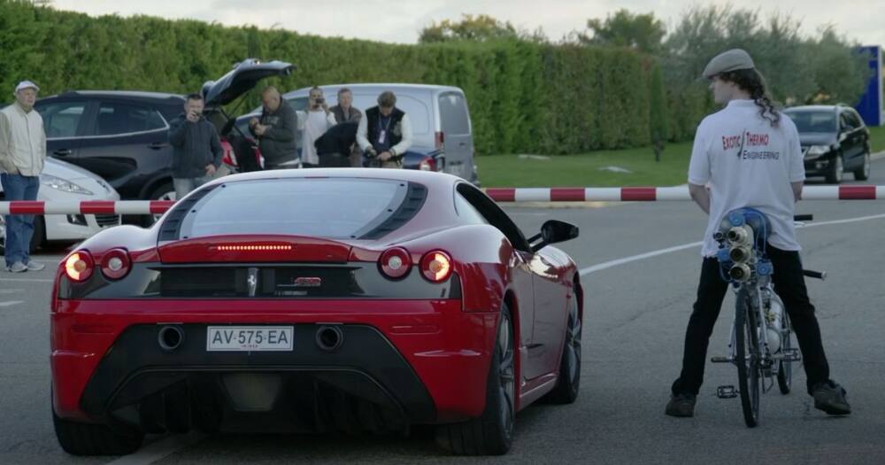 Man straps himself to super fast rocket powered bicycle and races a Ferrari, Internet reacts
