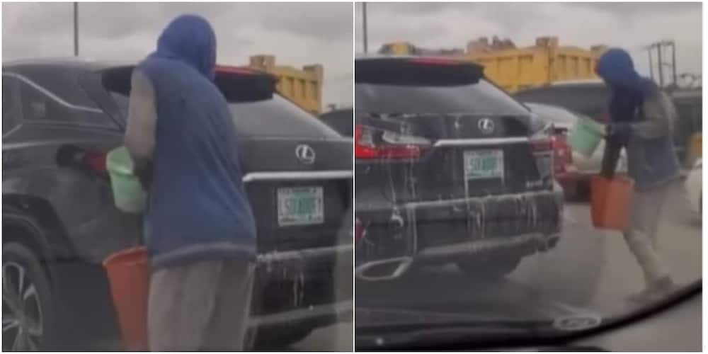 Man washing car in traffic