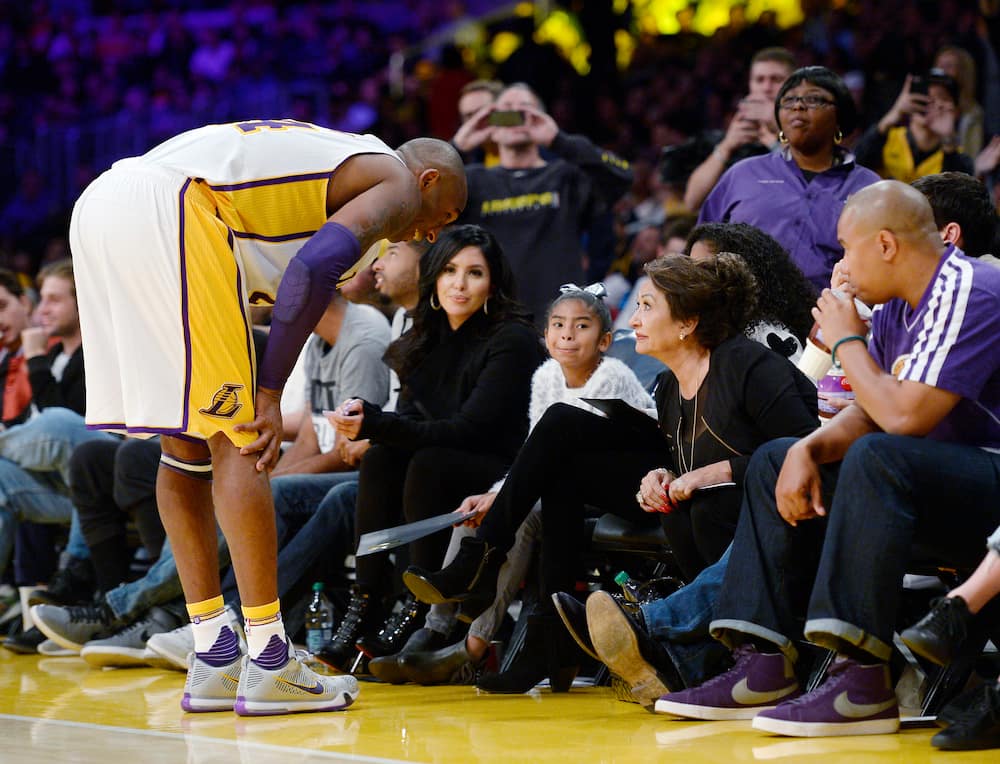Kobe Bryant of the LA Lakers talks with wife Vanessa, his daughters Gianna and Natalia, and mother-in-law Sofia during the game against Indiana Pacers at Staples Center on 29 November 2015.