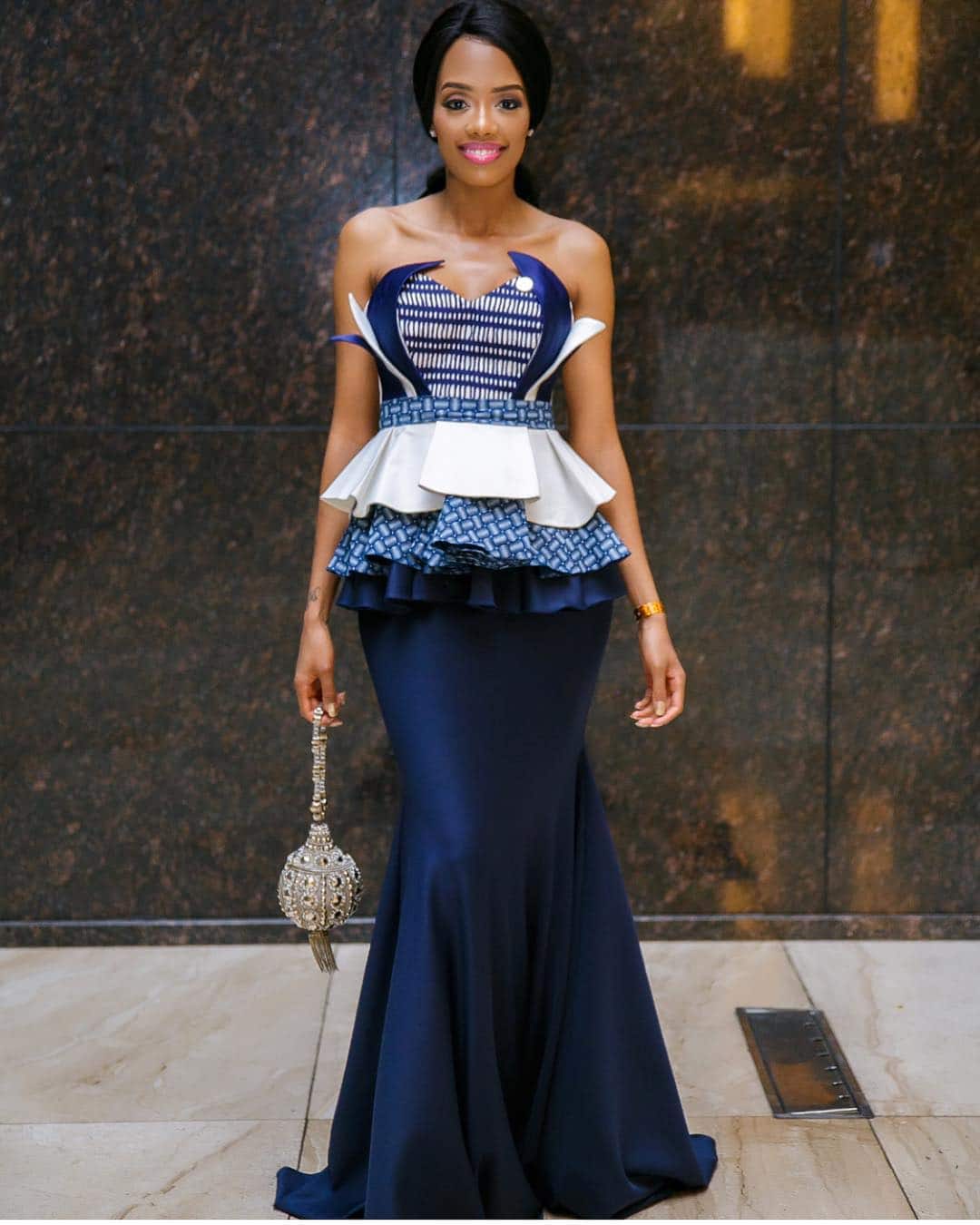 Long pleated blue prom gown.