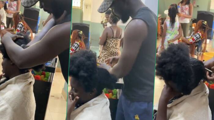 Ghanaian man shows care to wife, fixes ponytail hairstyle for her in public, video sparks reactions
