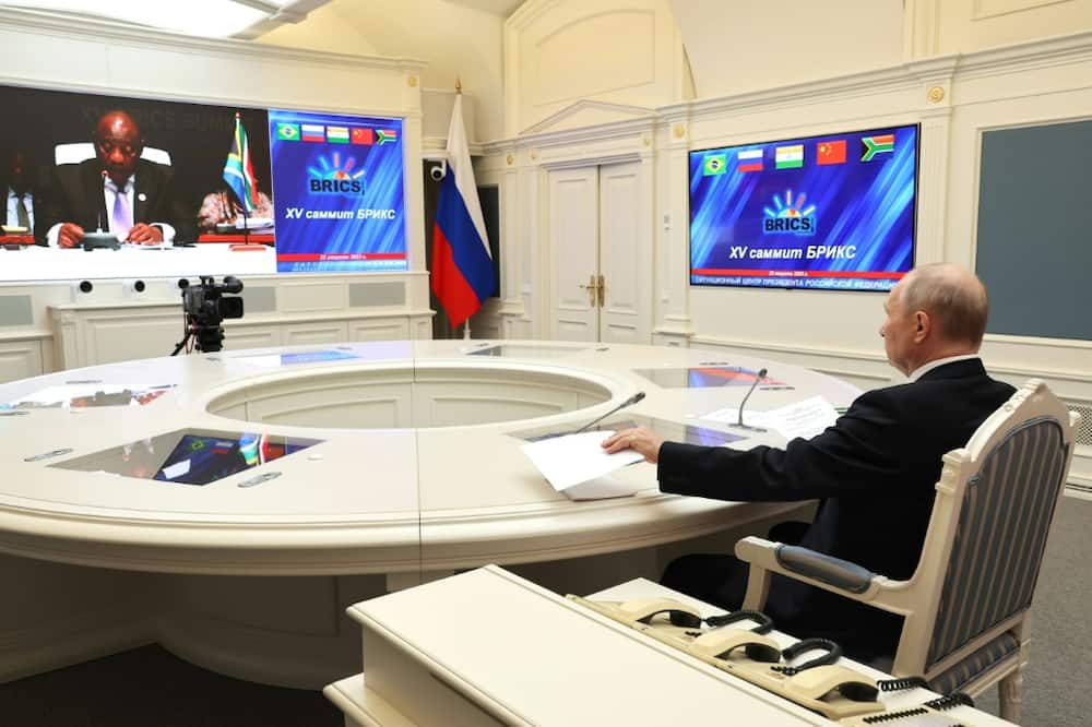 Putin, seen here in a picture distributed by the Russian news agency Sputnik, joined the summit by video link