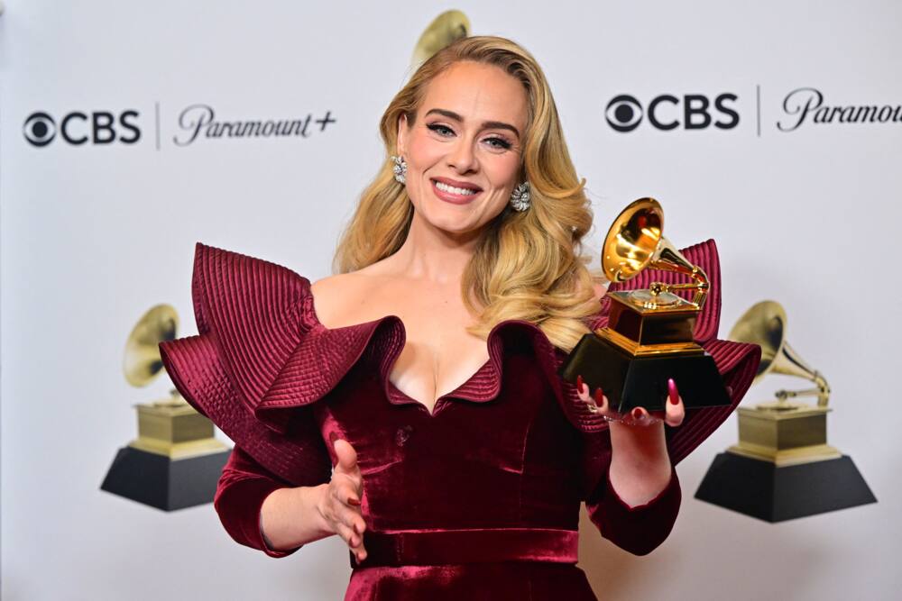 Adele poses with the award for Best Pop Solo Performance for Easy on Me