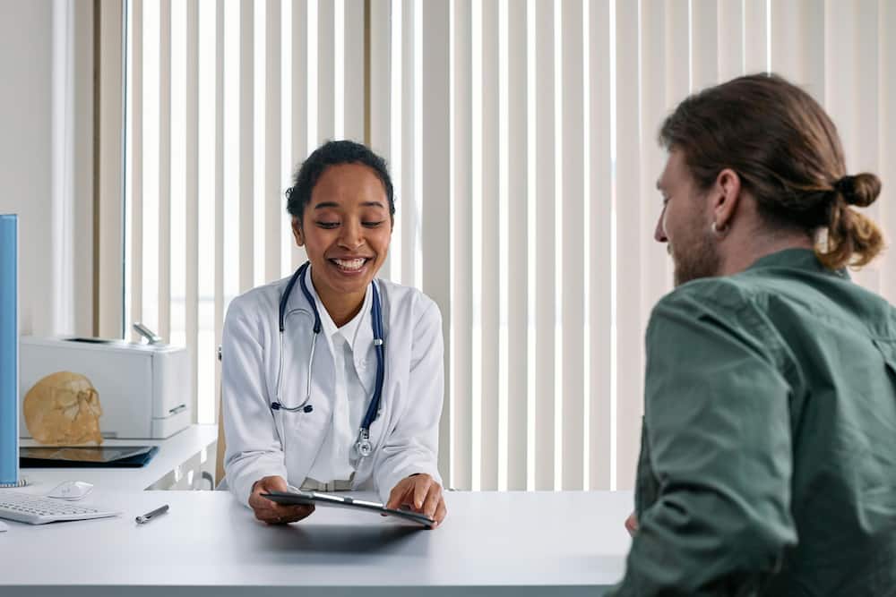 A young female doctor talking to a patient