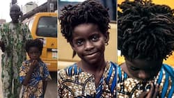 Photographer captures handsome black boy walking with blind father on road: "He looks like Rema"
