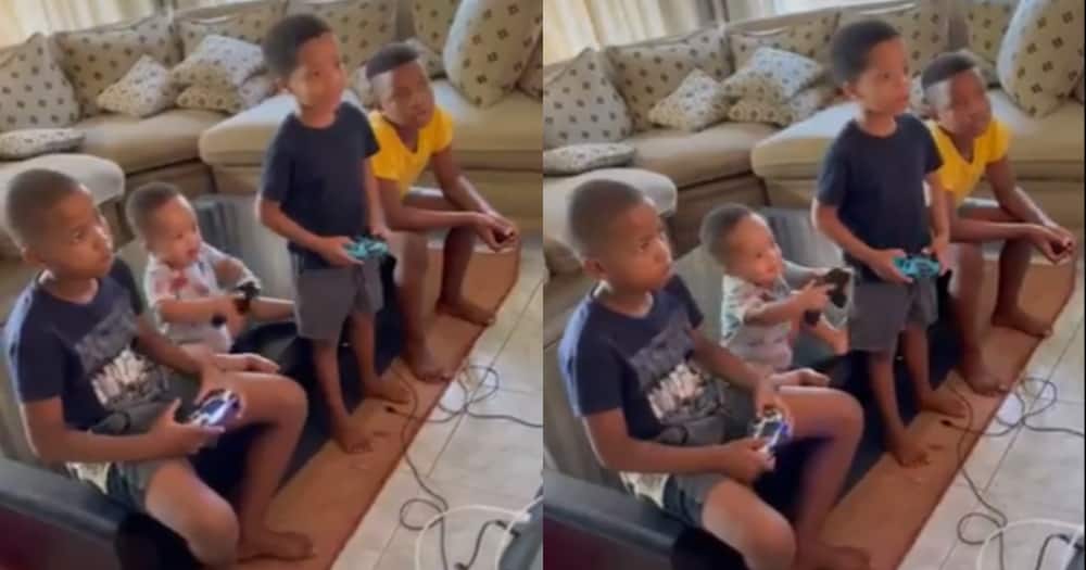 Siblings play cute console game control trick on fun loving toddler