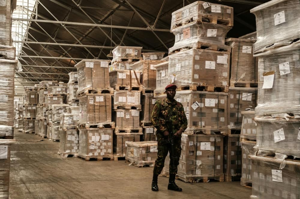 A soldier guards boxes of ballot papers for Kenya's elections